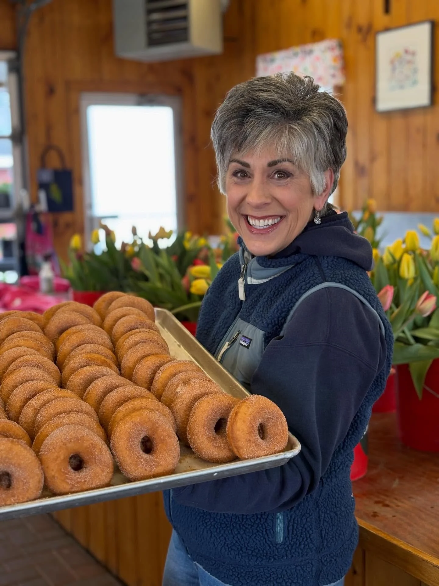 We recruit all of our friends and family to help make the tulip show run. Here&rsquo;s auntie Ruthie with Cider Donuts. We&rsquo;re making them round the clock.