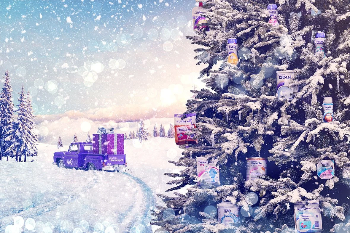 A snowy winter landscape with a decorated Christmas tree containing various supplement bottles as ornaments, and a purple vintage truck carrying a large present in the snow.