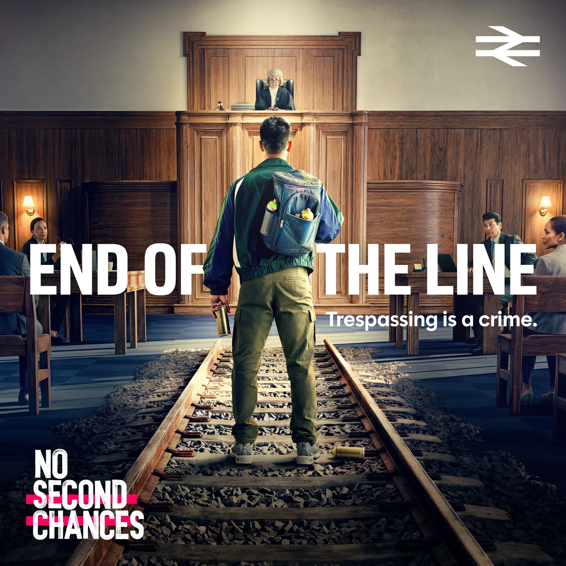 National Rail “End of the Line” advert showing a man on railway tracks inside a courtroom, warning that trespassing is a crime.