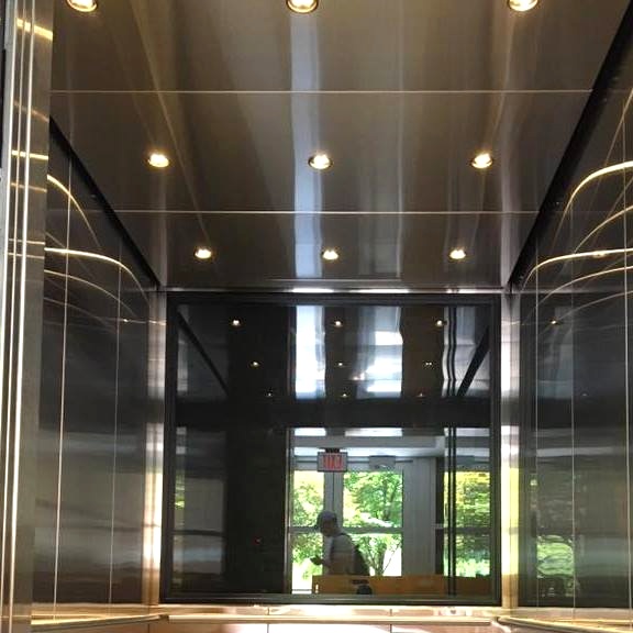 Installed brushed stainless steel ceiling and LED downlights.