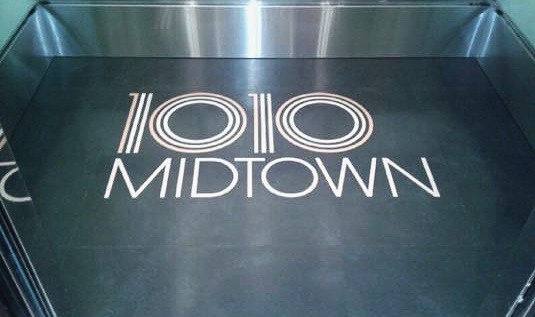 1010 Midtown - Installed flooring with custom logo.