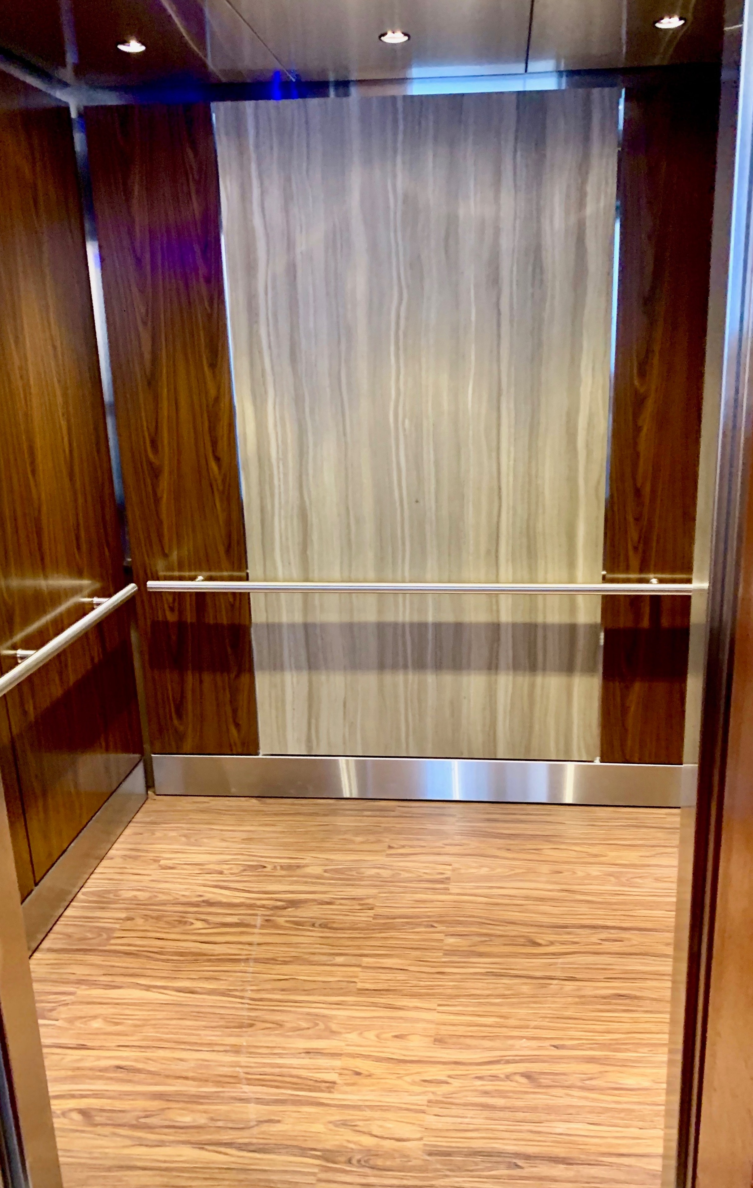Emory Conference Center Hotel - Installed brushed stainless steel ceiling, composite material on the center panel on the back wall, veneer panels on the side walls and stainless steel reveal package.