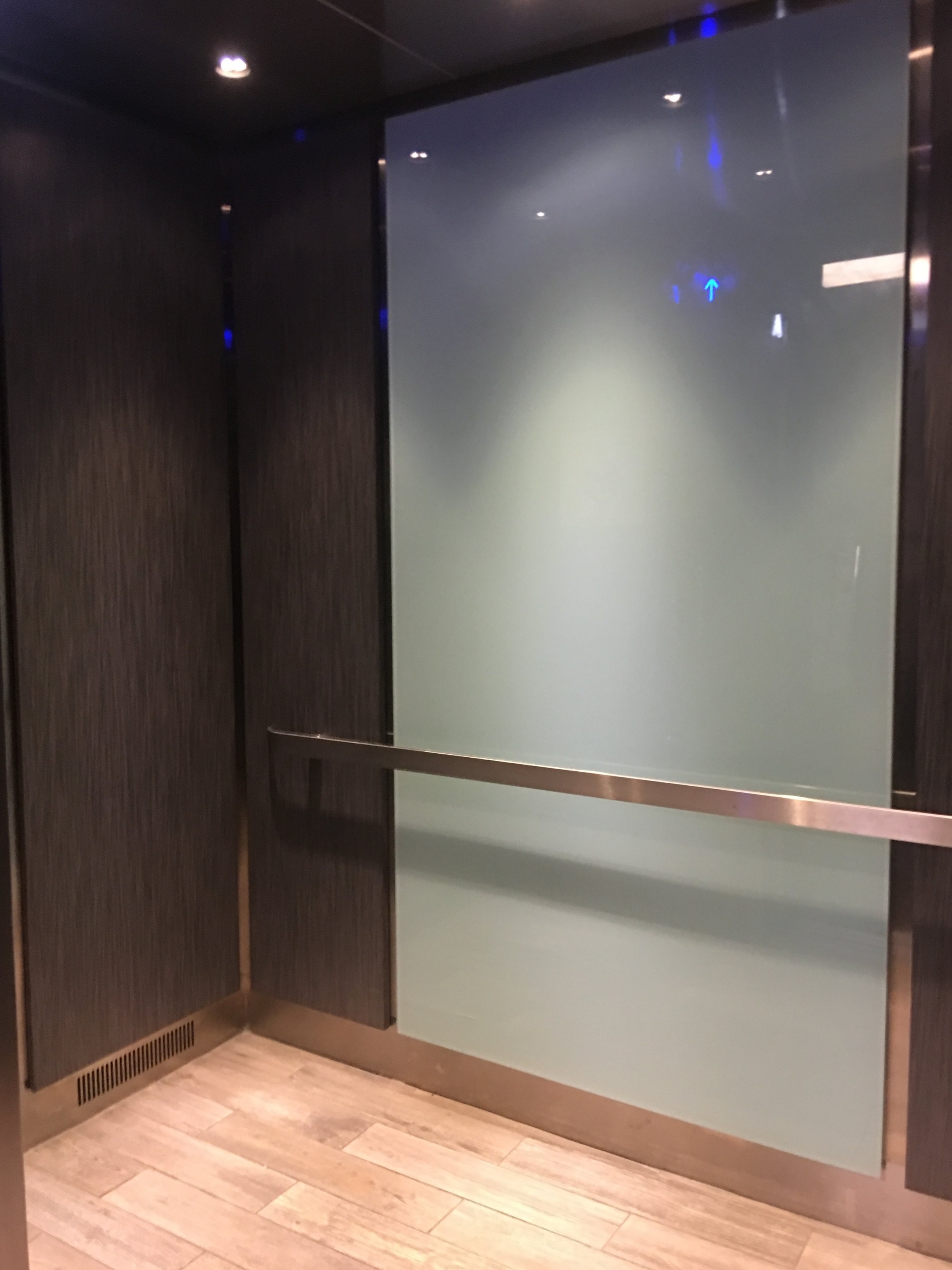 Hampton Inn Buckhead - Installed brushed stainless steel ceiling with LED downlights, glass center panel on the backwall and laminate panels on the sidewalls and brushed stainless steel reveals.