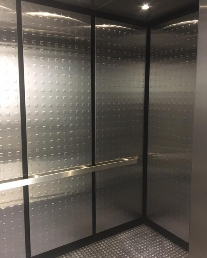 Georgia Tech Family Housing - Installed brushed stainless steel ceilings, LED downlights, architectural metal wall panels, black powder coated reveals with ROPPE flooring.