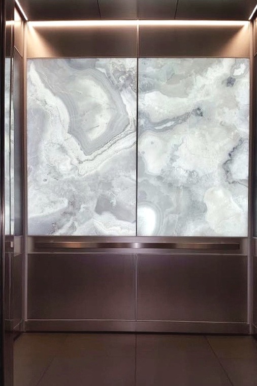 Metropolis - Installed brushed stainless steel ceiling with perimeter lighting.
