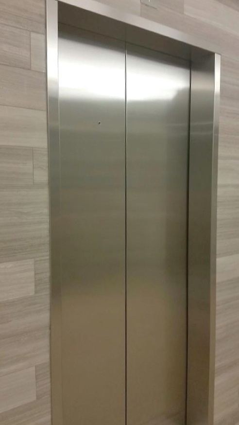 Installed brushed stainless steel entrance frames.