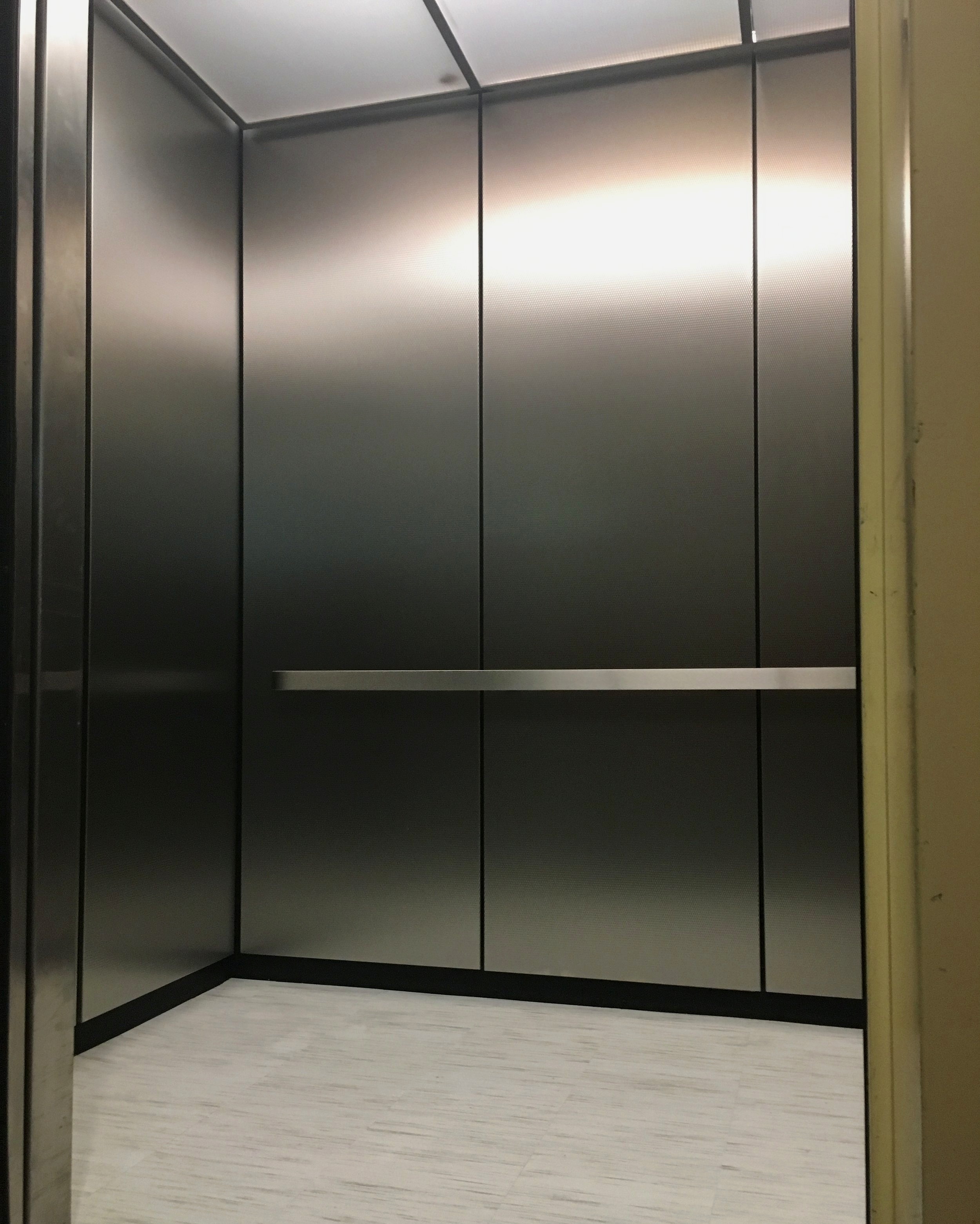 Life University - Installed T-Frame ceiling, LED lighting, architectural metal wall panels, brushed stainless steel handrail with Laminate Vinyl Tile flooring.
