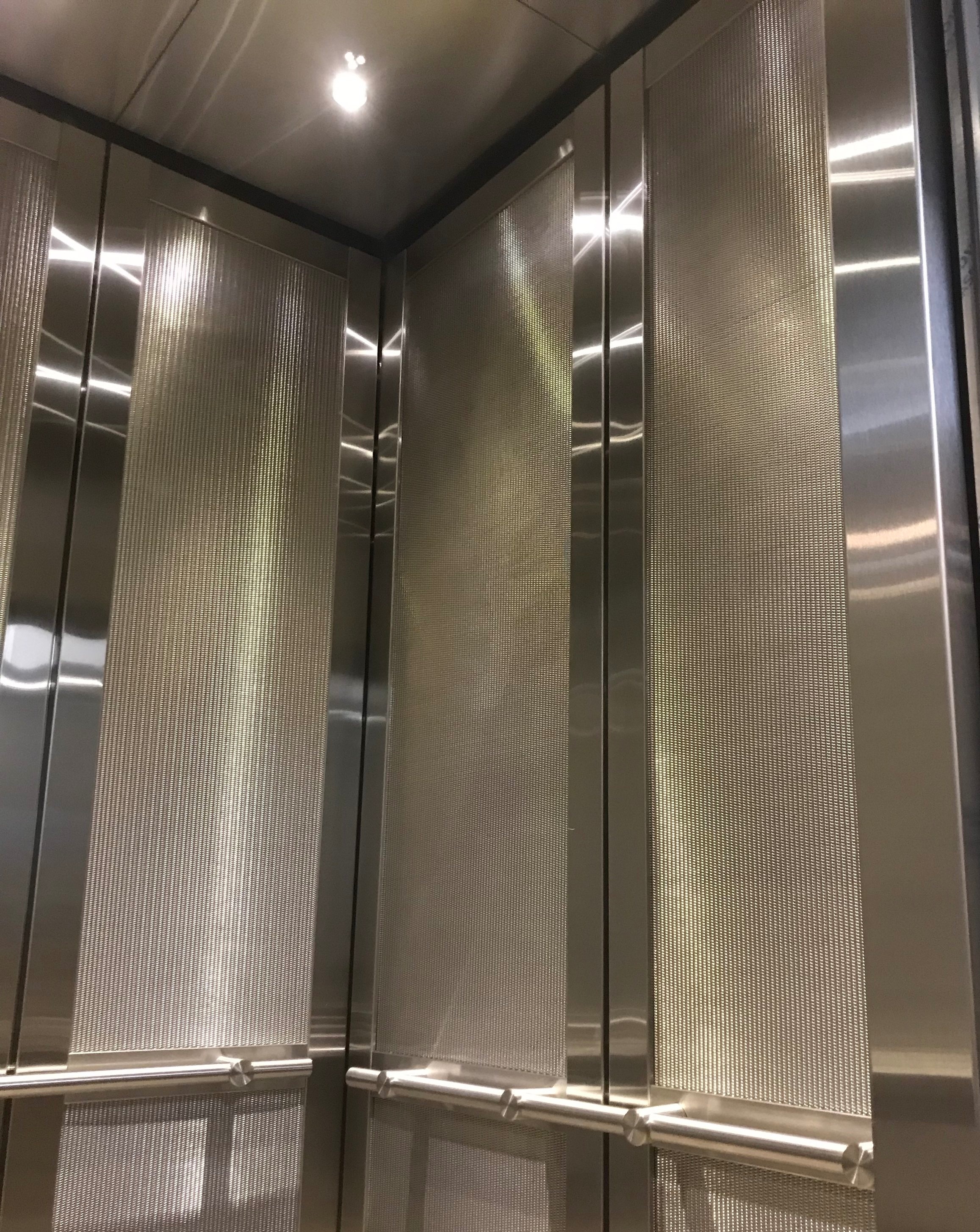 Decatur Town Center - Installed architectural stainless steel wall panels with brushed stainless steel trim pieces and carpet flooing.