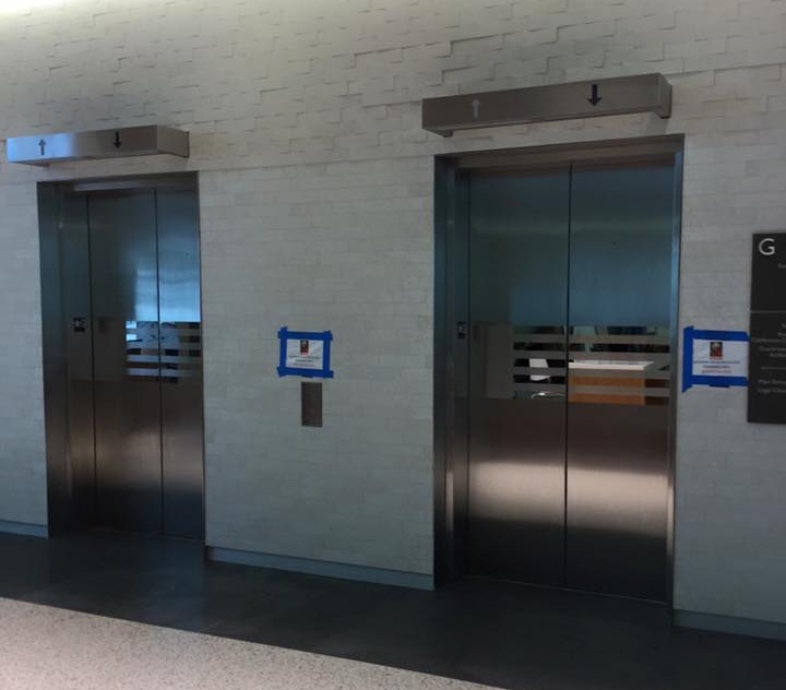 GSU Law Building - Installed brushed stainless steel entrance frames and brushed stainless steel hoistway door cladding with polished accent stripes.