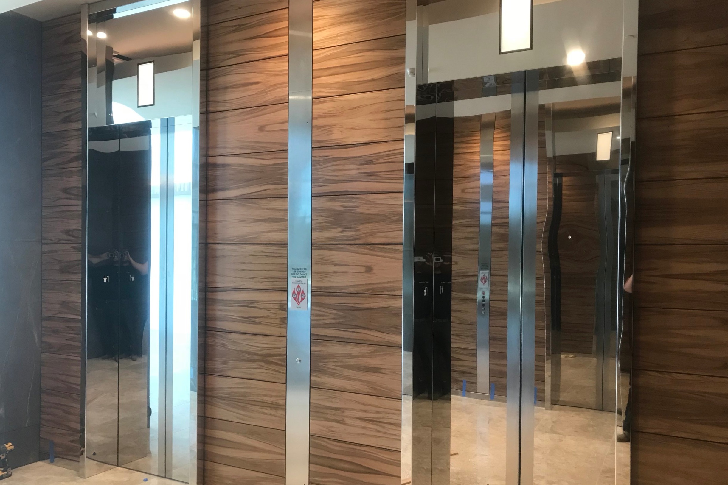 4004 Summit - Installed mirrored stainless steel entrance frame cladding.