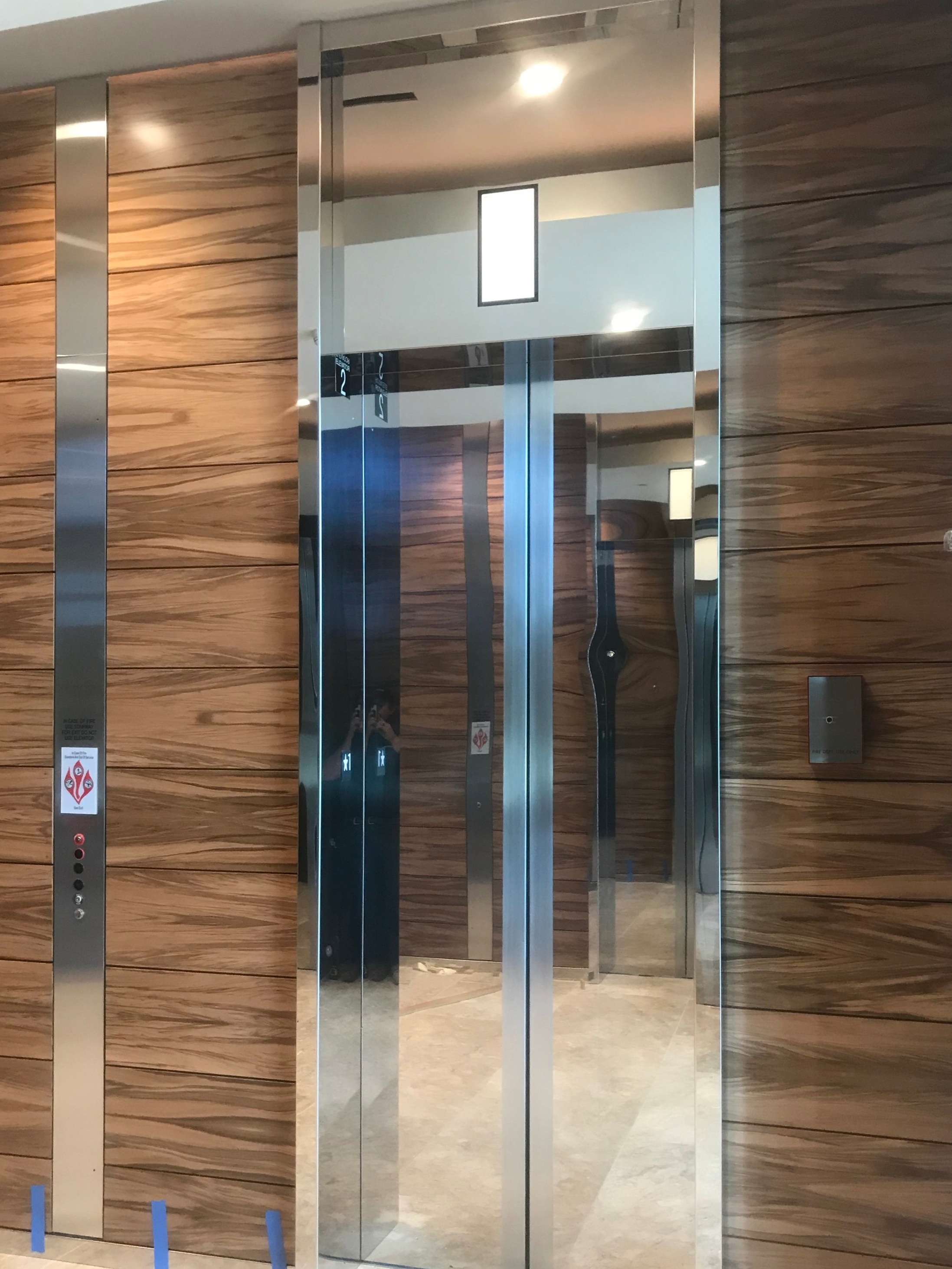 4004 Summit - Installed mirrored stainless steel entrance frame cladding