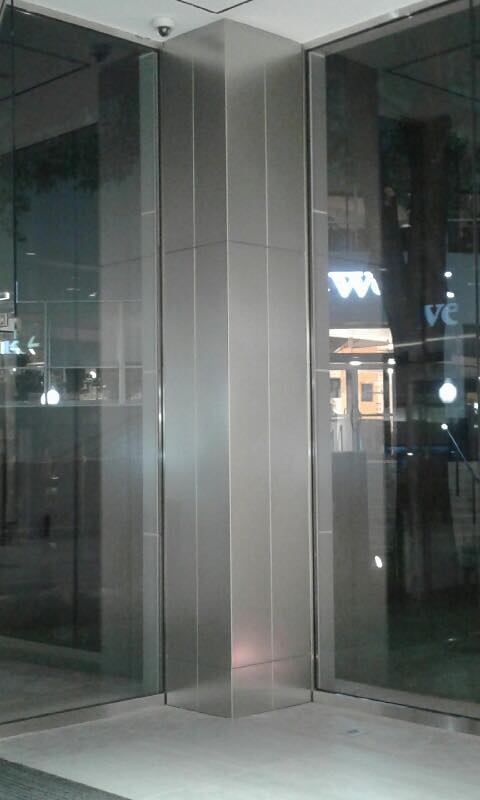 Tower Place 100 - Brushed stainless steel cladding around columns