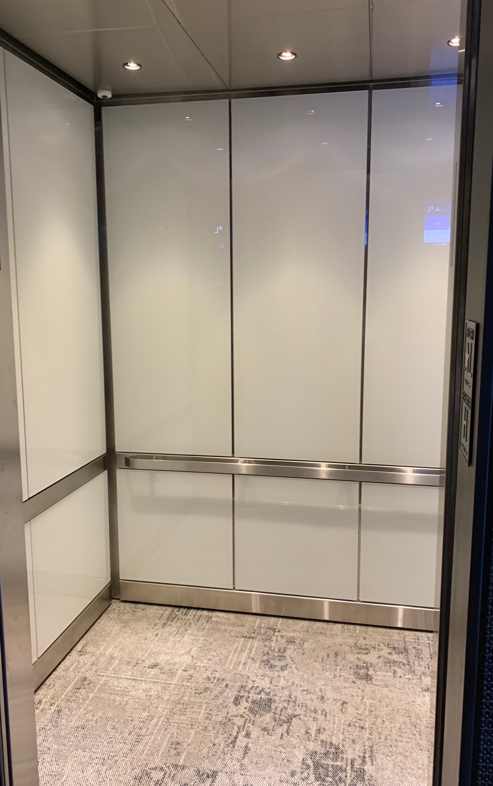 Capital City Plaza - Installed glass panels on all walls, brushed stainless steel ceilings, brushed stainless steel reveal package, installed carpet