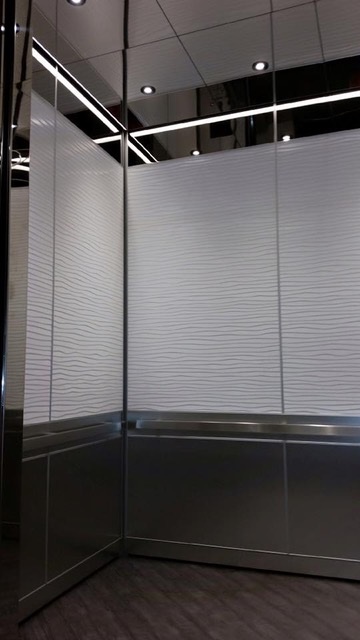 12 Hotel - Installed elevator ceiling, wall panels, reveal package with carpet flooring.
