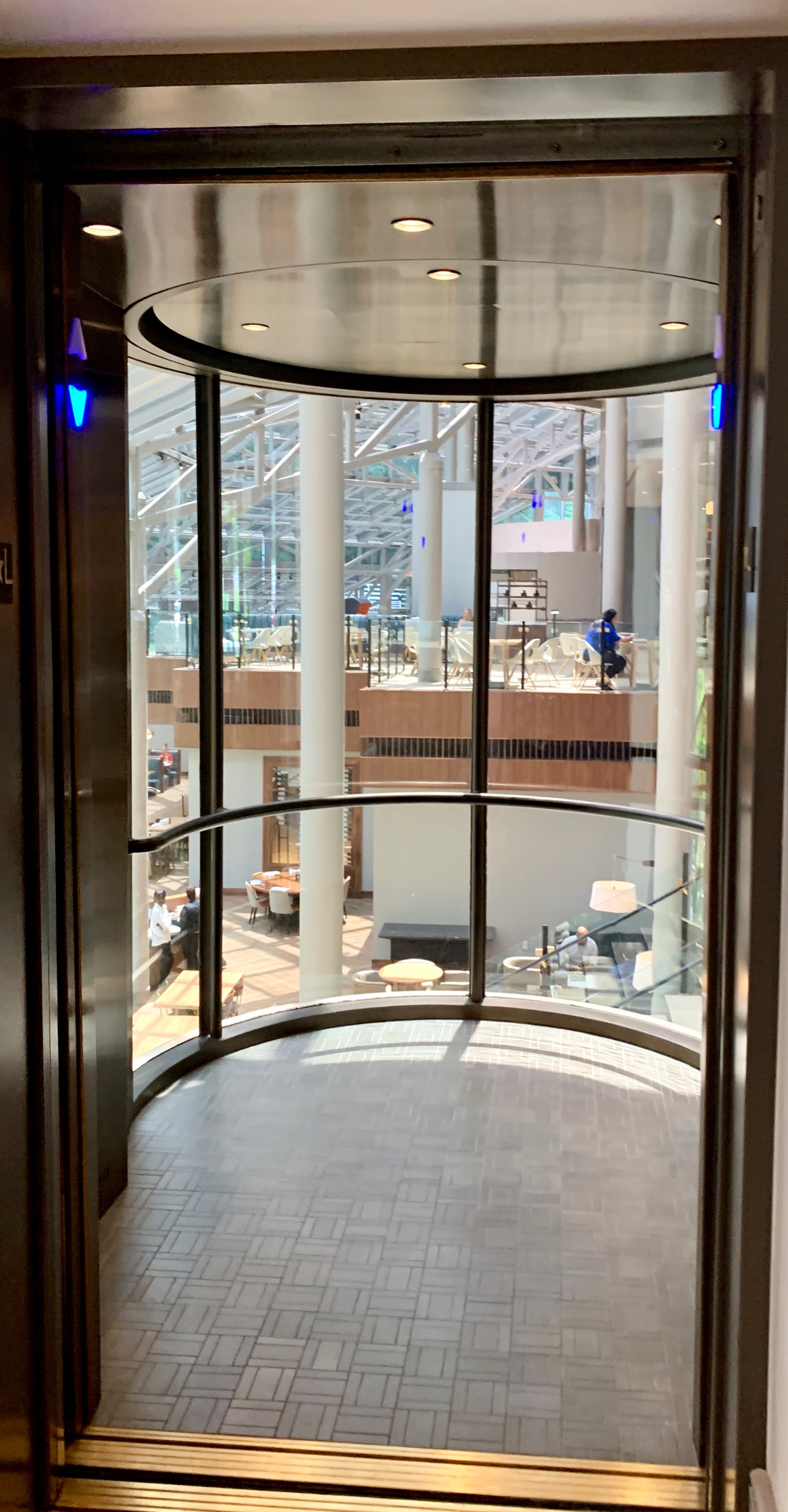 Crown Plaza Atlanta Perimeter at Rivina - Fabricated and installed medium bronze ceiling and cab front cladding in atrium cab with tile flooring.