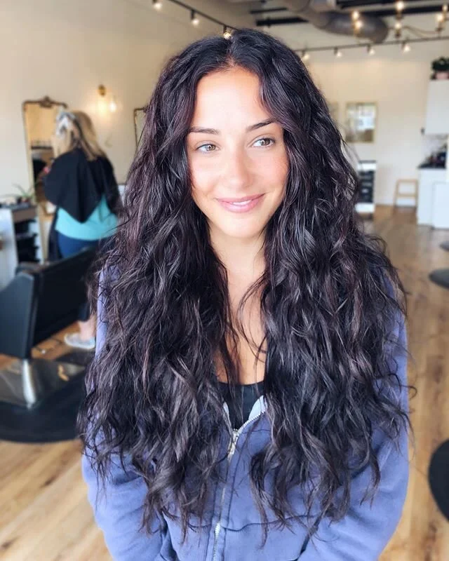 Big &amp; boujee with all the curly plum hair! This color is so hard to do justice in photos, but the curls are showing more of its tones 😍 We mixed 2 rows of @isla.naturalbeadedrows 22&rdquo; wavy &amp; smooth hair to mimic her natural curls &amp; 