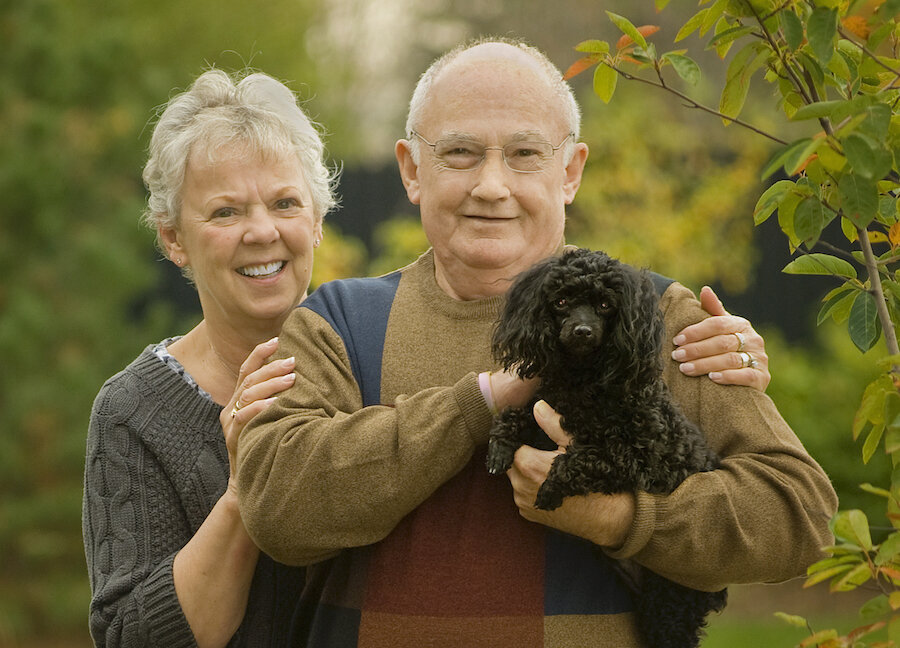 Patient with nasal prosthesis after cancer, supported by his family. 