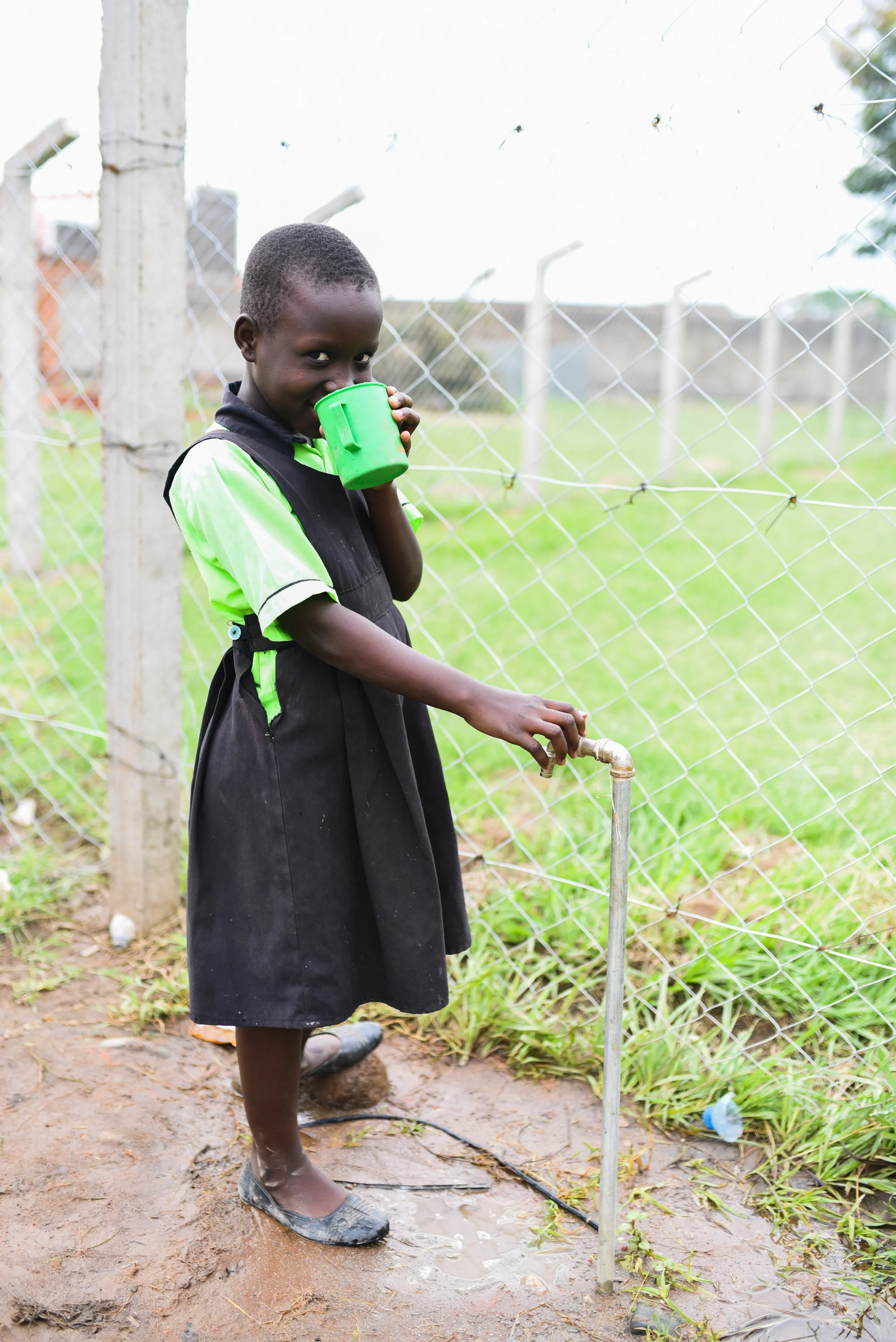 Queen, 9, P4, drinking water on tap at the new campus.
