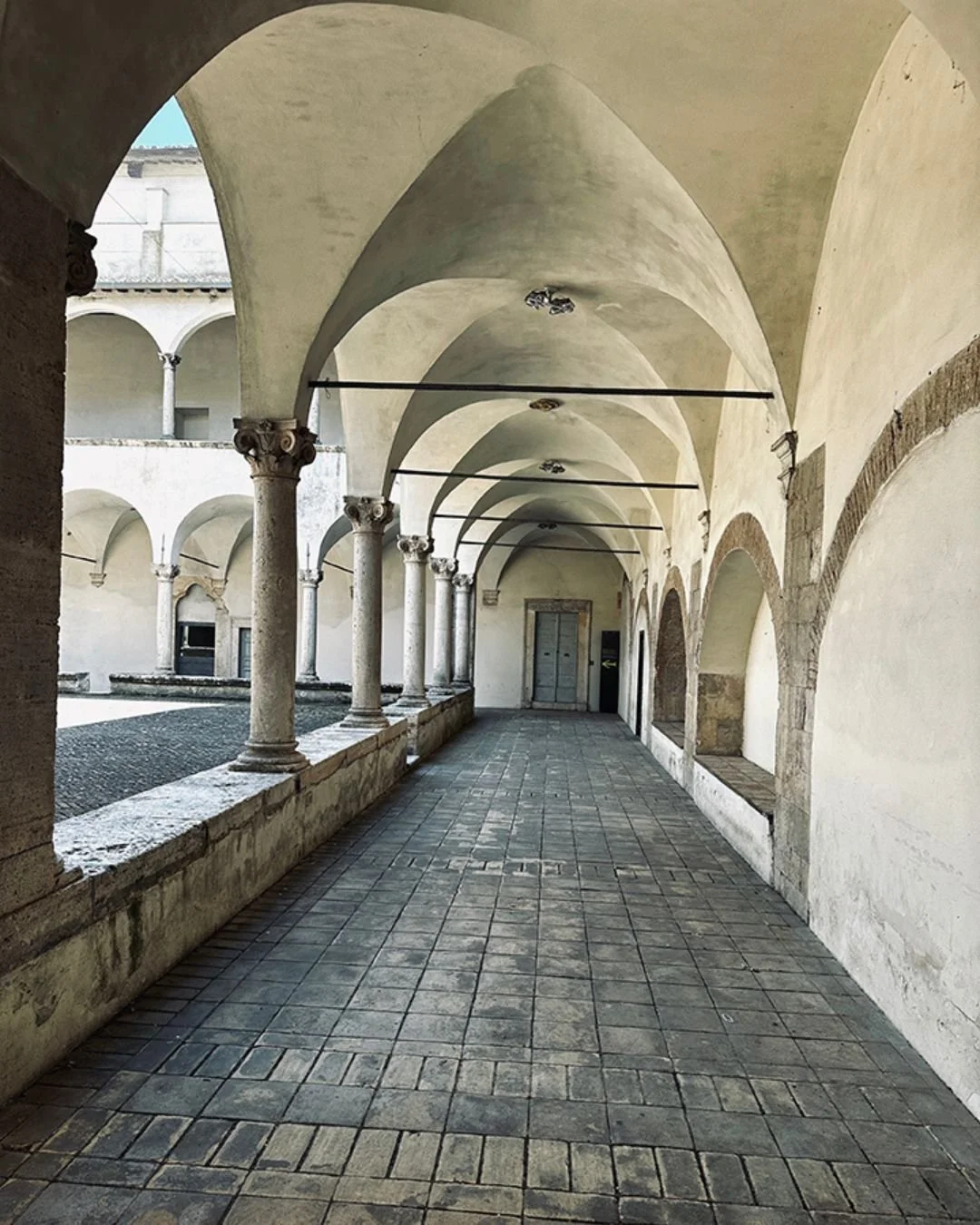The Collegio Boccarini cloisters in Amelia, Italy. Stone arches and floors.
