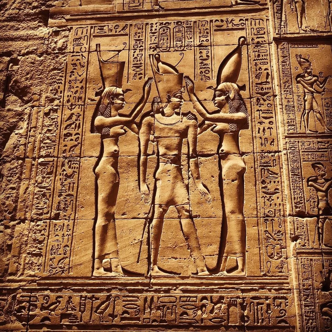 hieroglyph of the crowning of the King at Edfu temple symbolizing the unification of lower and upper Egypt. Mut is seen in human form here as well as vulture form.