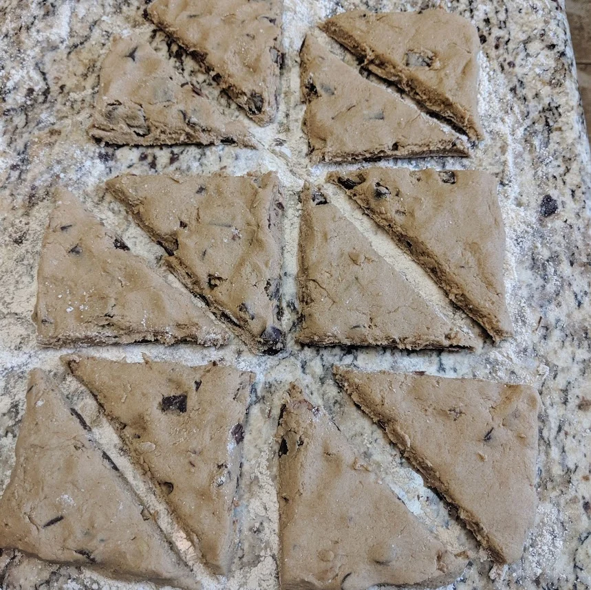 From there, cut each square in half diagonally to form a total of 12 triangles.