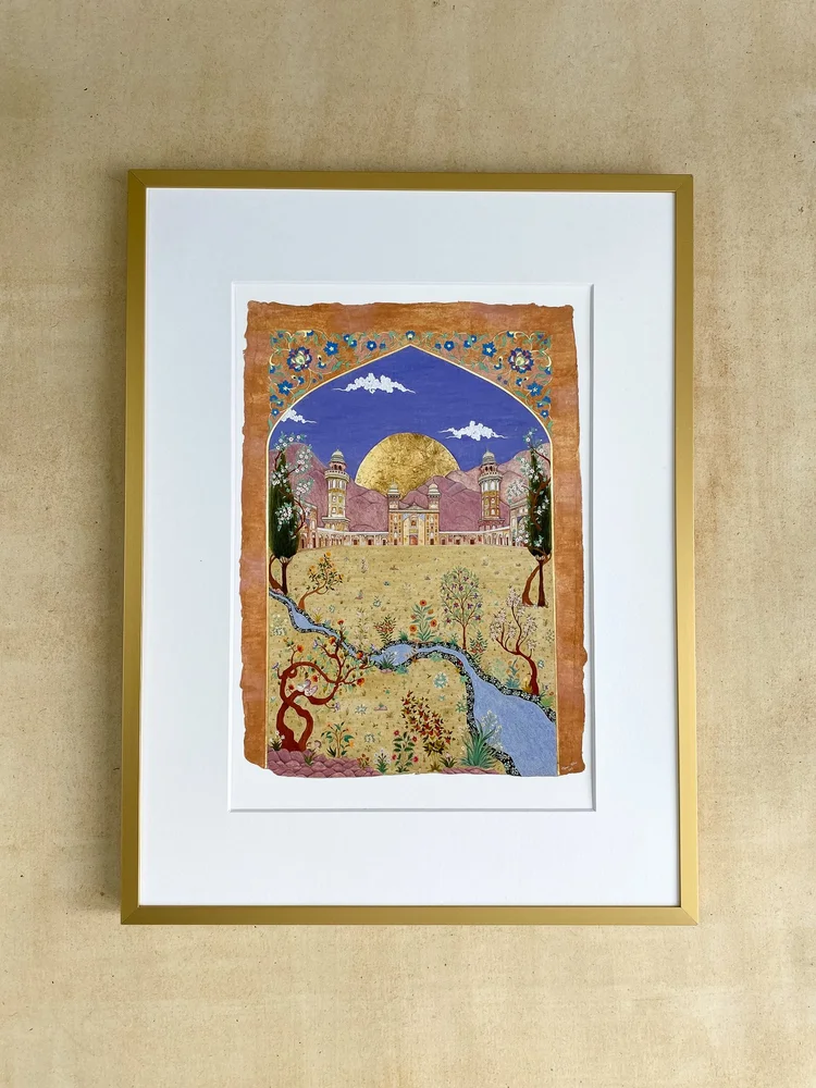 Garden of Reflection art print by Mobeen Akhtar in a gold-coloured frame, showing a garden, river and domed building beneath a blue sky.