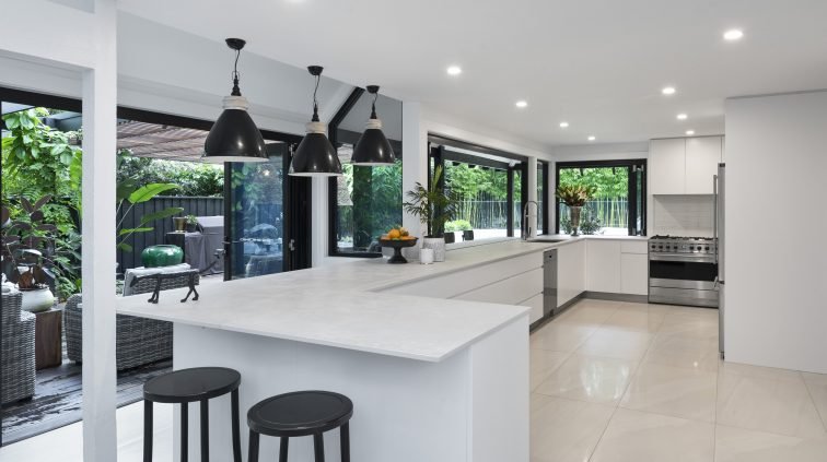  Large kitchen with plenty of prep space, dining areas and clean white marble surfaces 
