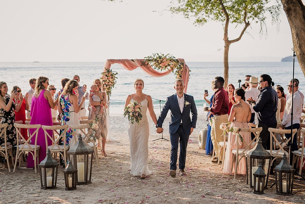 Wedding Ceremony on the Beach Newlyweds walking on beach Four Seasons Costa Rica.jpg.jpg
