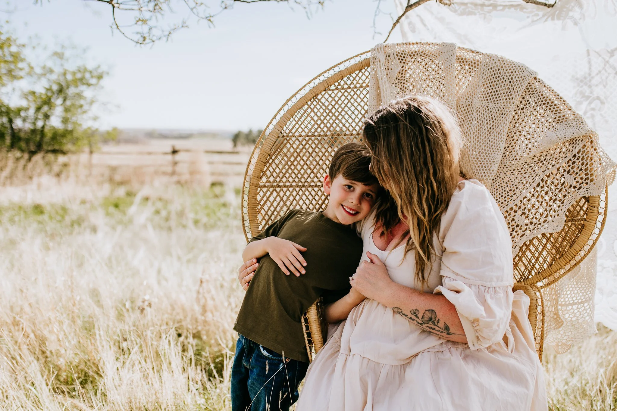 Mother hugging young son during outdoor motherhood portrait session in North Dakota