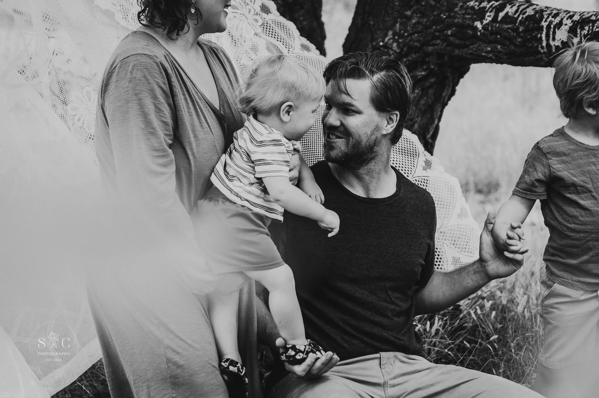 Dad and son laughing together during spring mini session in Dickinson North Dakota