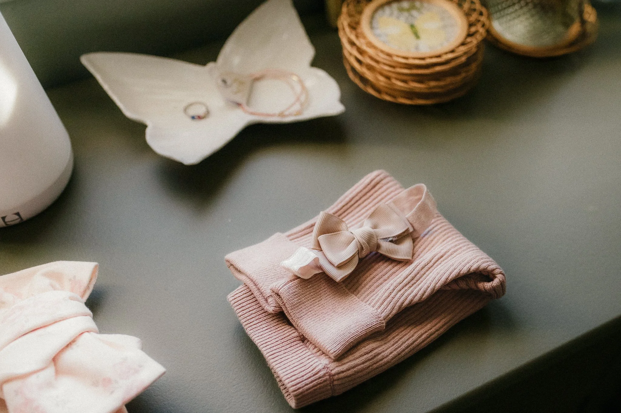 Soft, neutral baby outfits styled for natural in-home photography