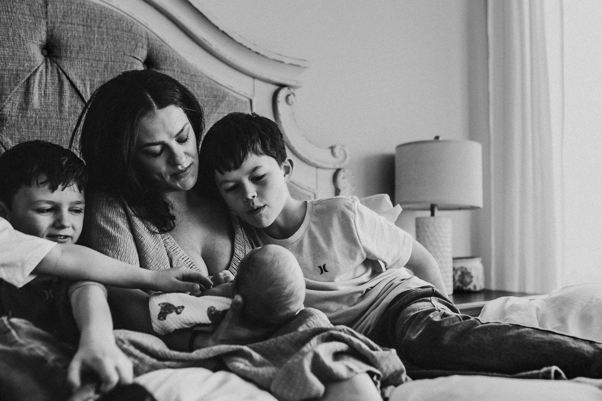 Relaxed newborn photo session in a tidy, cozy primary bedroom in Dickinson ND