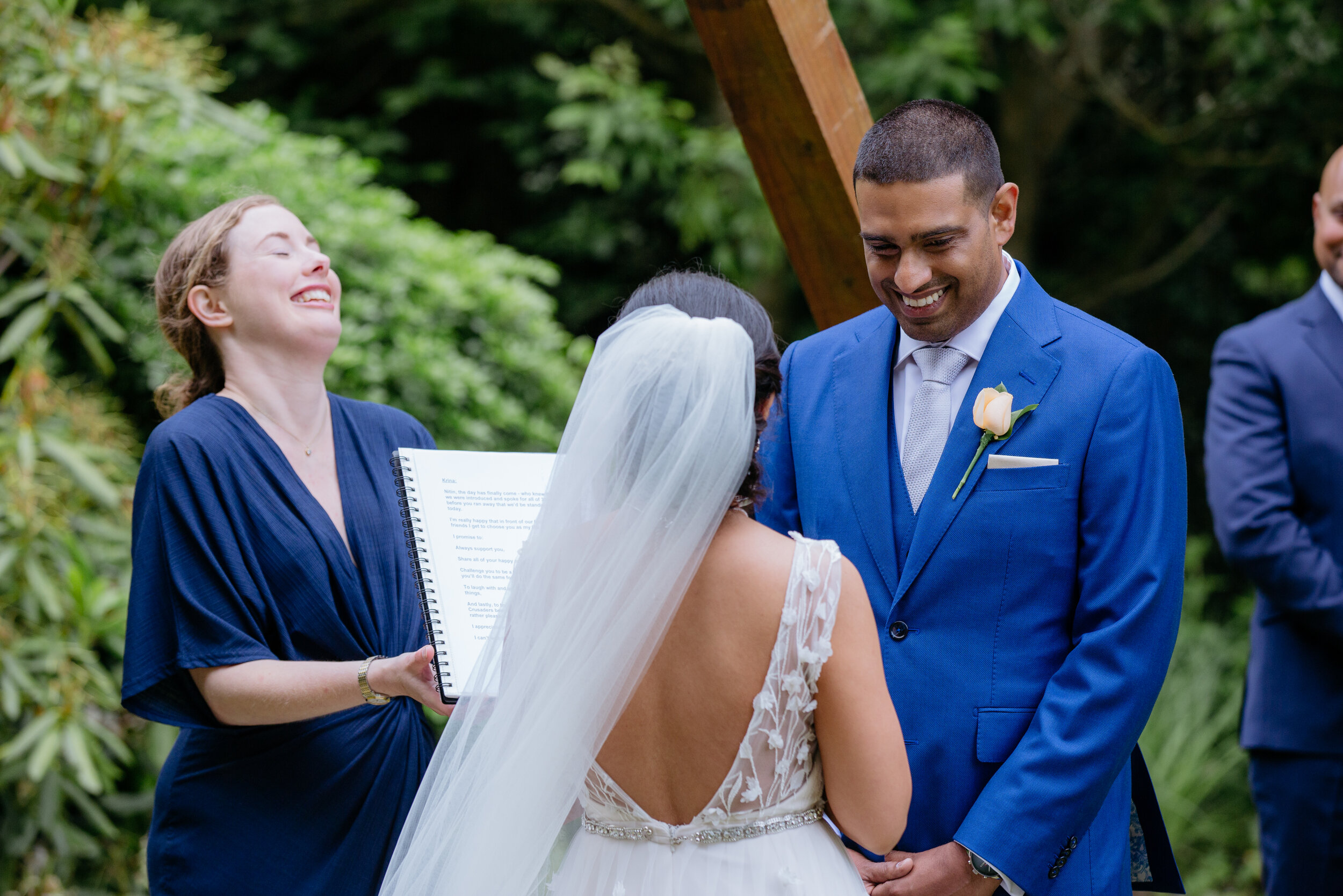 Celebrant laughing as Bride and Groom exchange vows