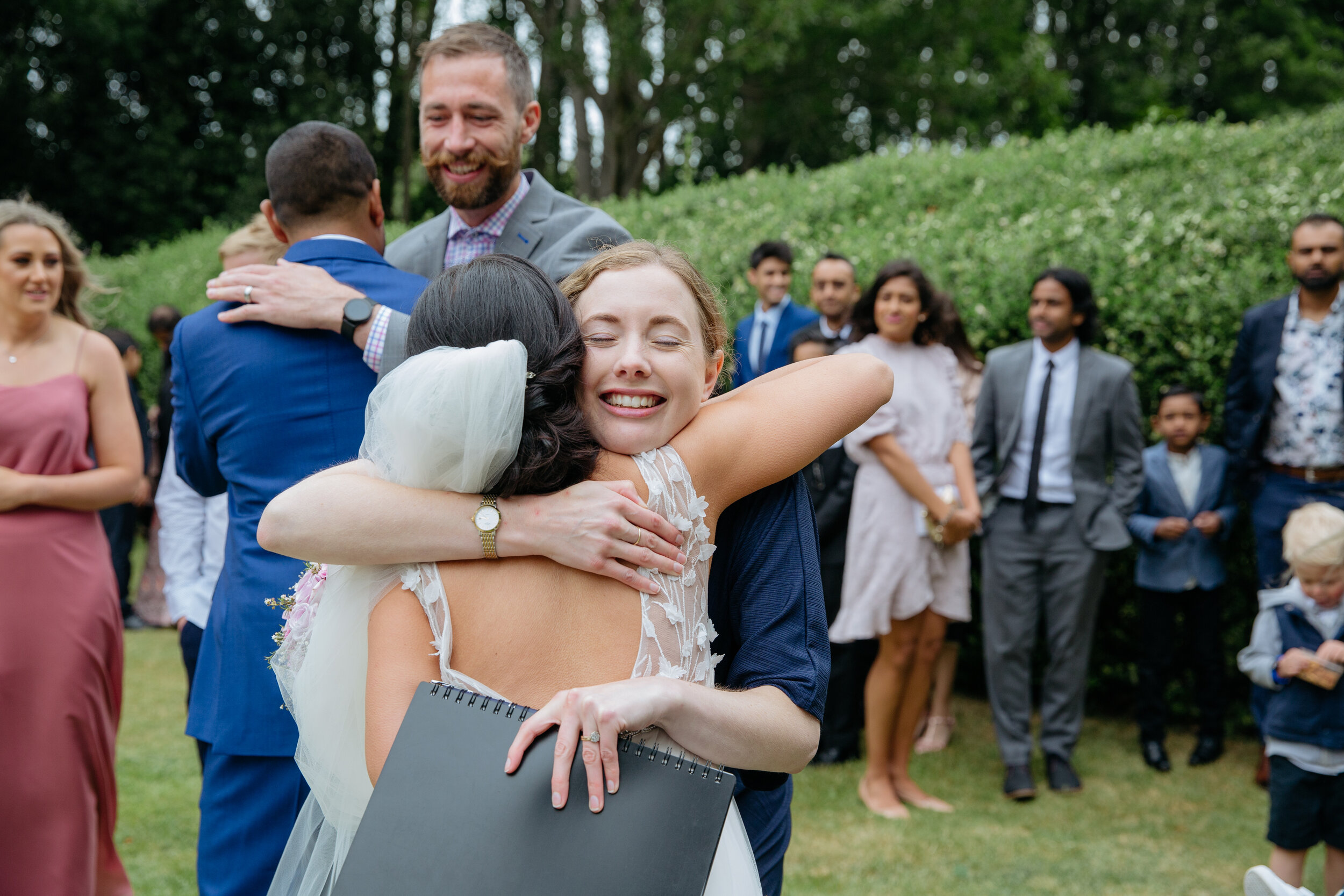 Celebrant hugging bride after New Zealand wedding ceremony at Pemberton Gardens