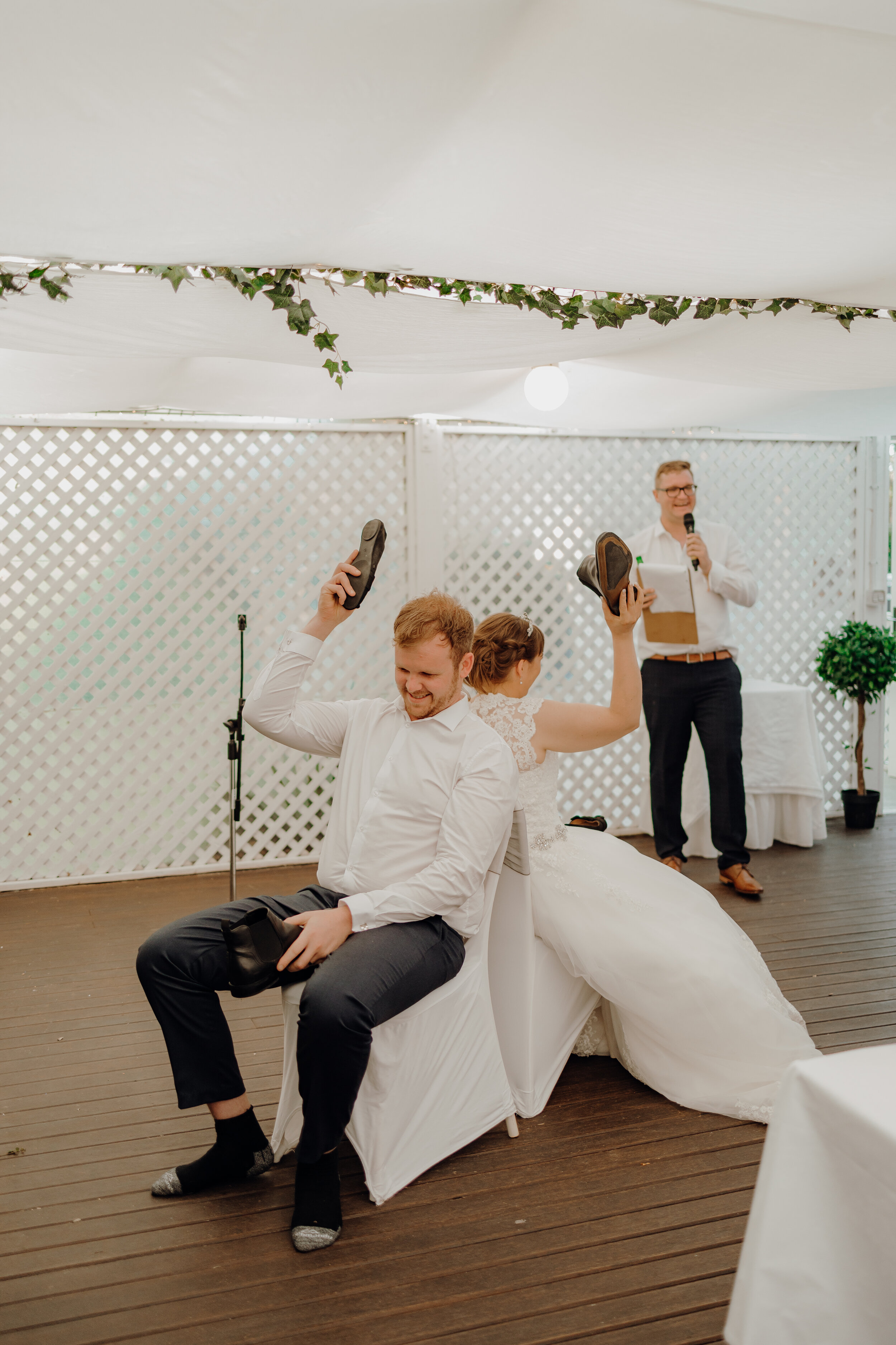 Bride and Groom playing 'The Shoe Game' at wedding reception