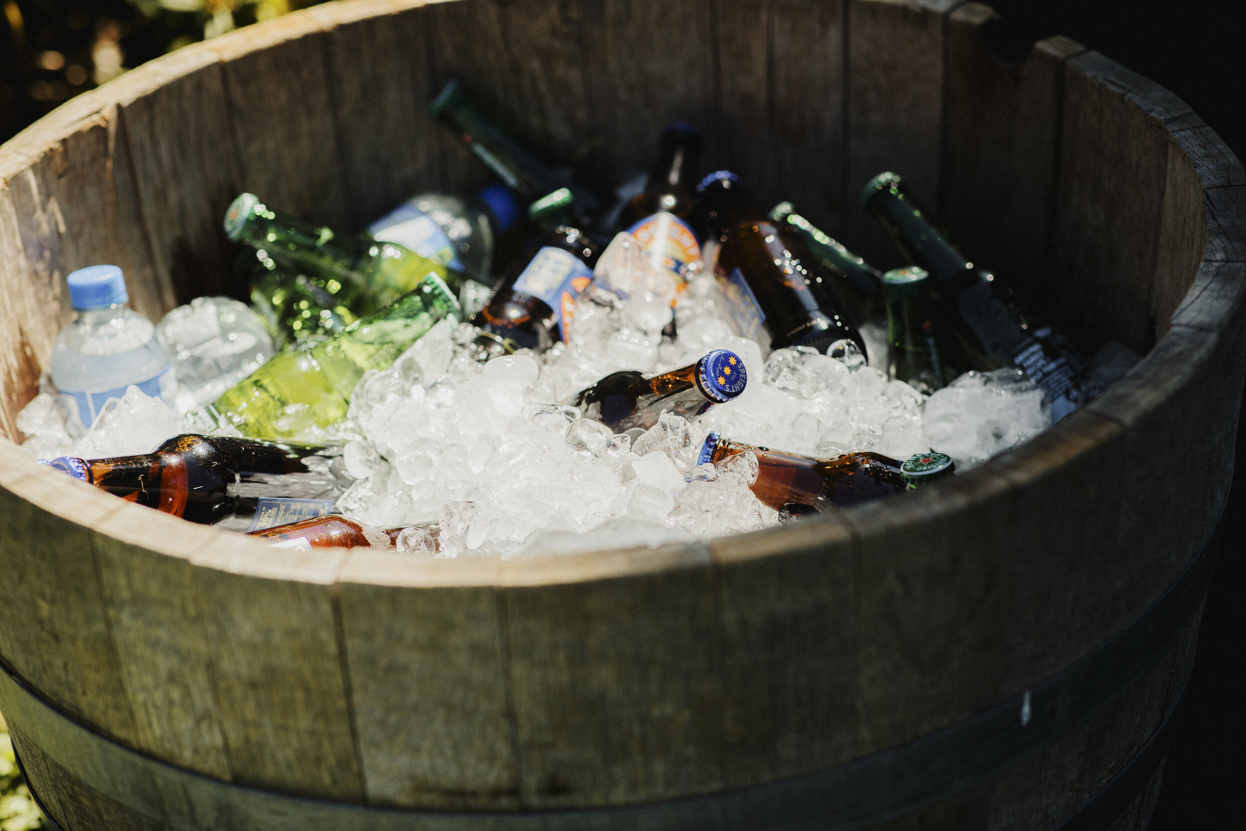 Rustic wooden ice bucket with beverages