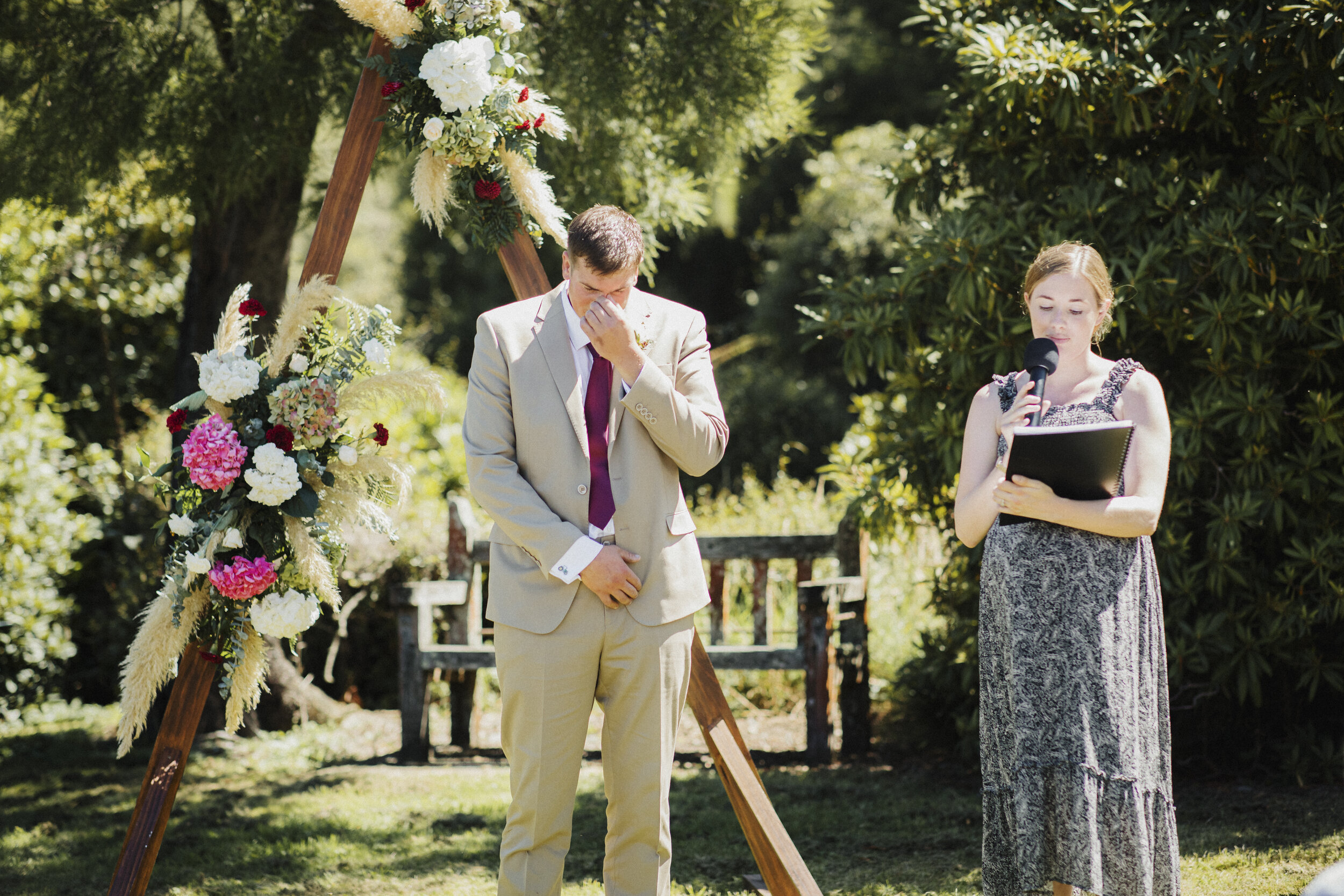 Groom crying at front of aisle as he awaits bride