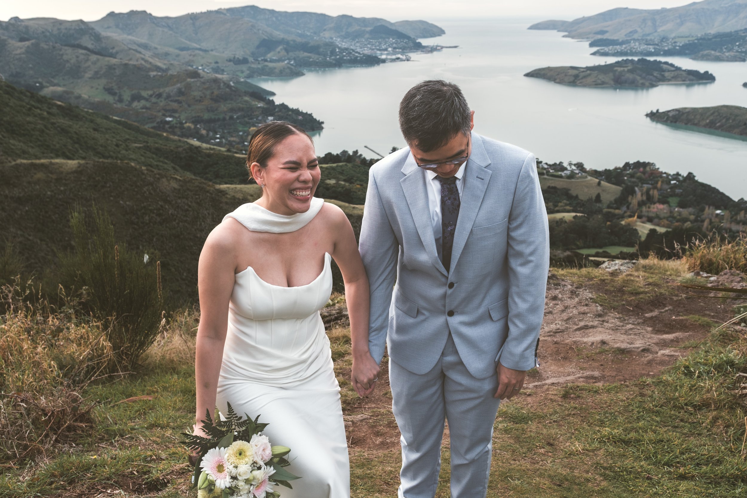 Couple beaming and holding hands