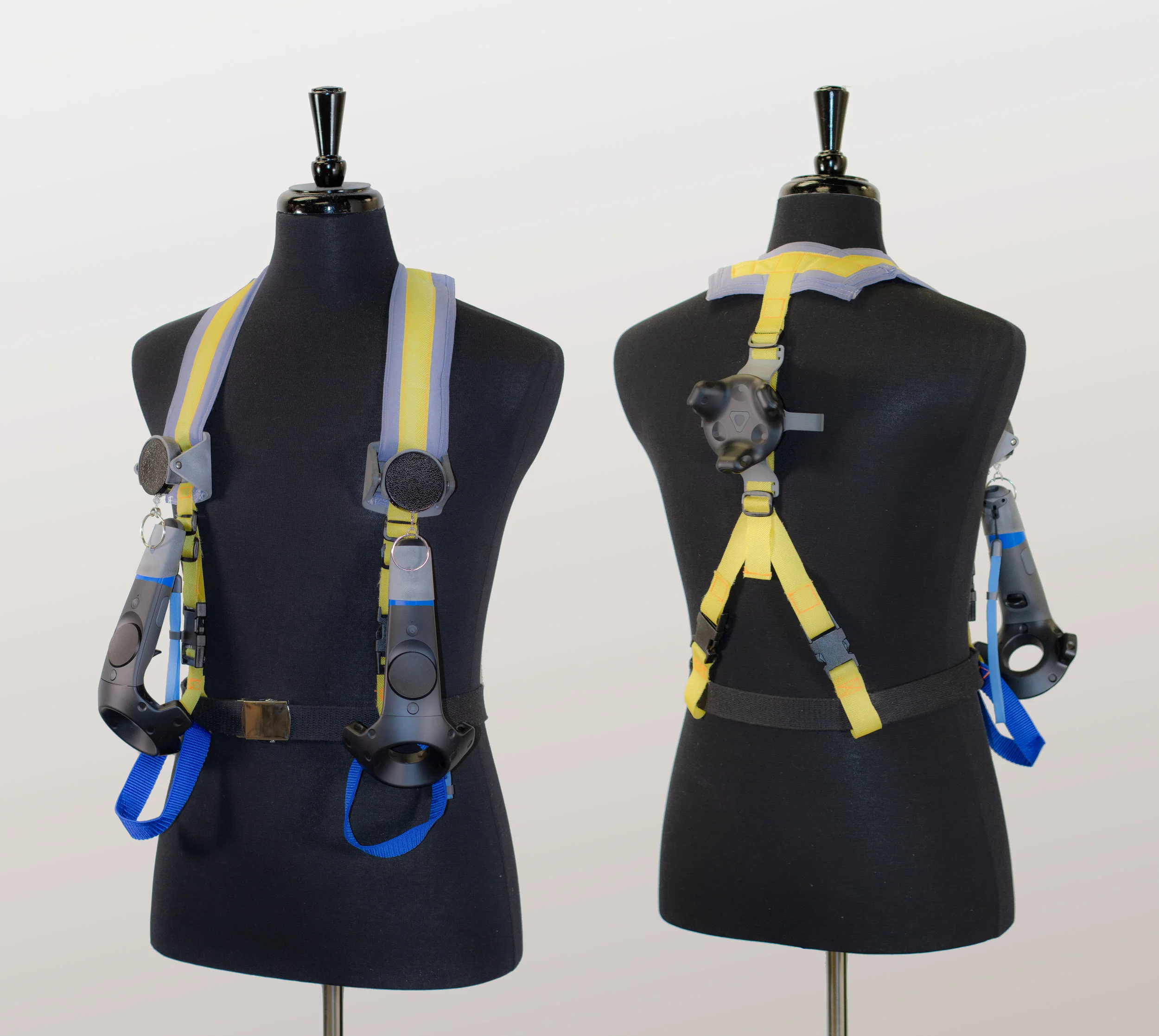 Jetpack Harness This harness allows the user to be tracked and to navigate in VR. The prototype includes retractable lanyards attached to the VR controllers, a VR tracker on the back, as well as holsters for the controllers if the user decides to di…