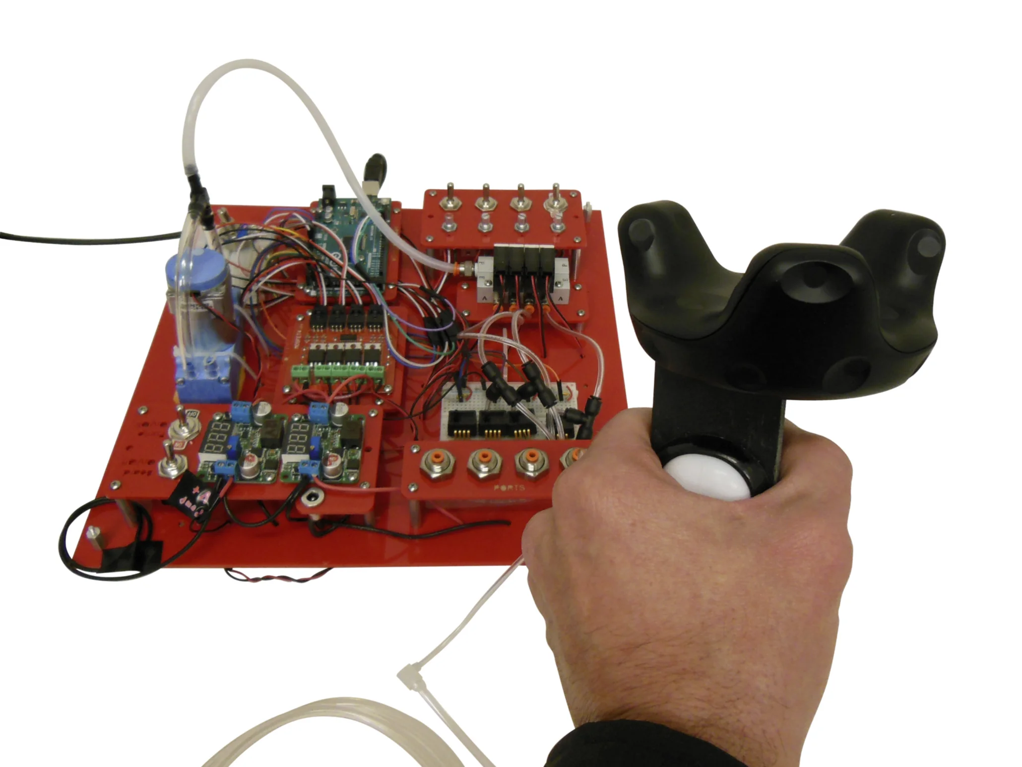 Controller shown with HTC Vive tracker and attached to soft robotics toolkit.
