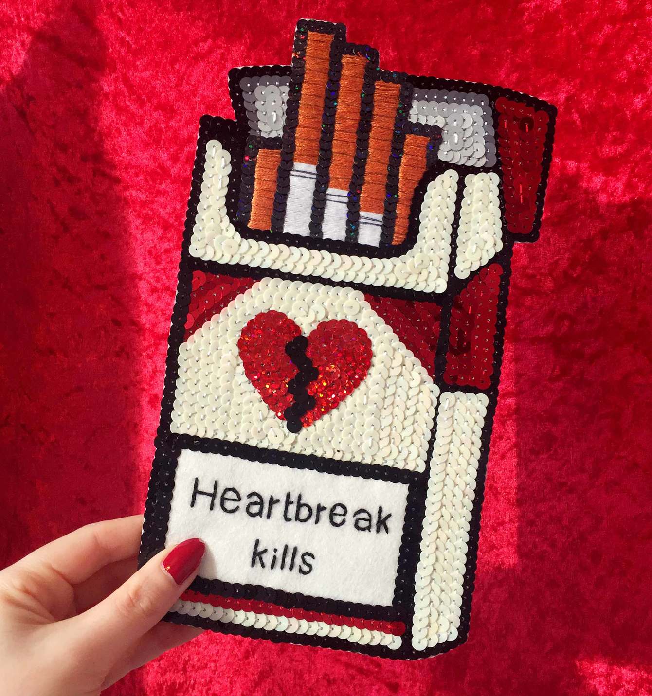 embroidered sequin "heartbreak kills" cigarette pack, 2016, Sophie King