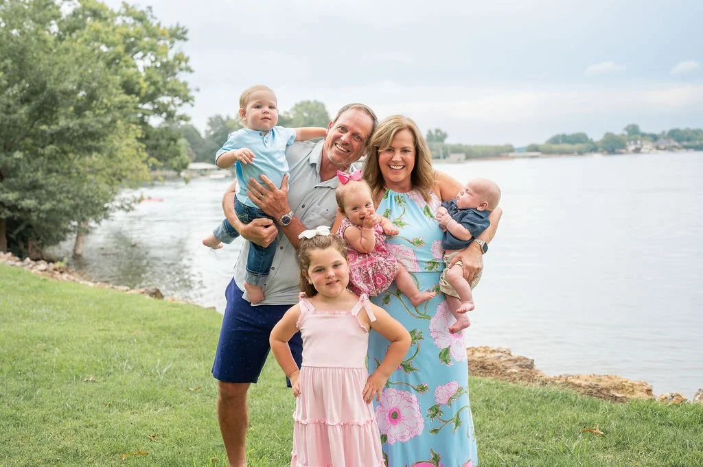 grandparents hold their four grandkids at an outdoor family session in lake norman nc
