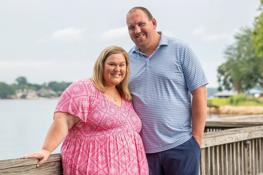 man and woman pose for photo during outdoor family session at lake norman