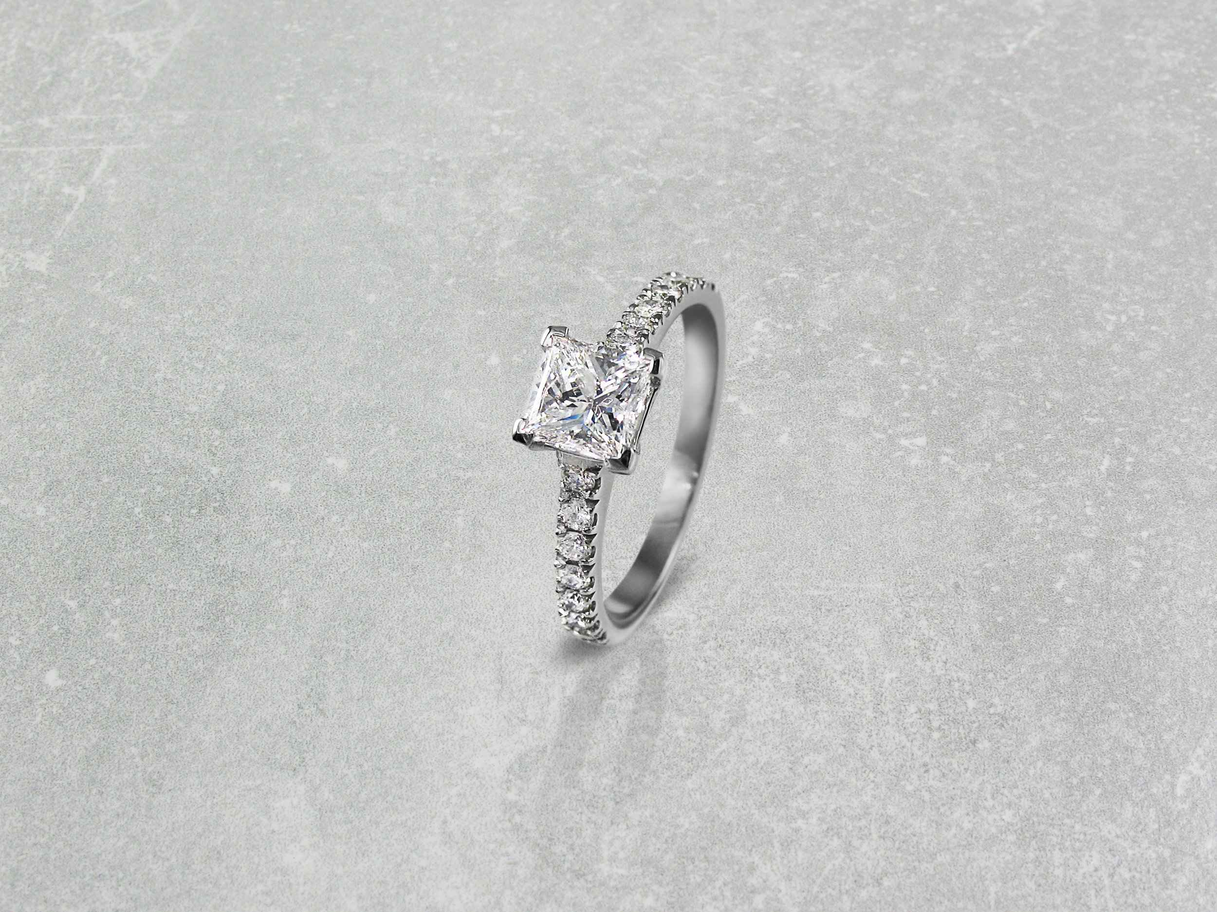 Princess cut diamond four claw engagement ring with diamond band