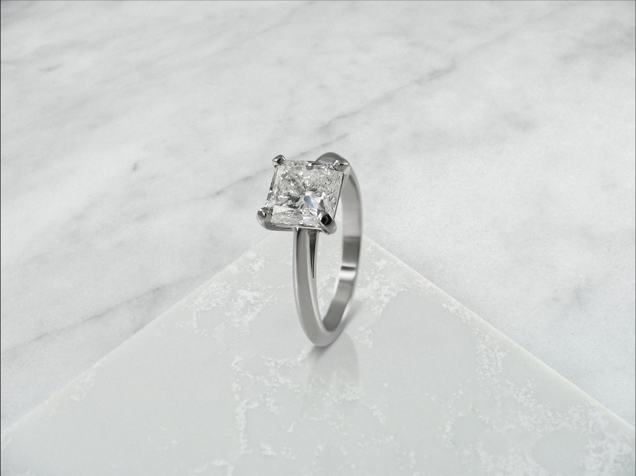 Radiant cut diamond four claw solitaire engagement ring