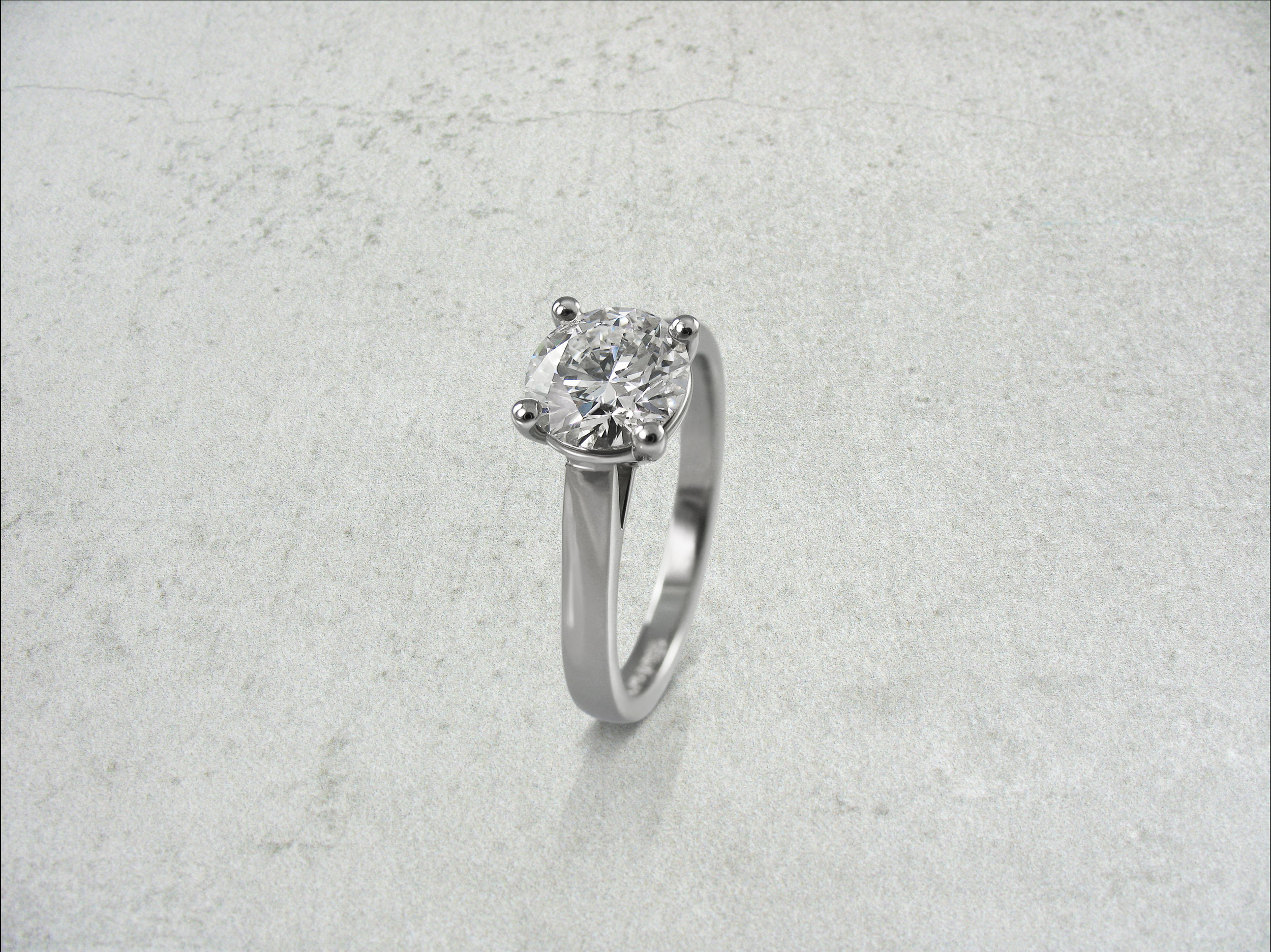 Round brilliant cut diamond four claw solitaire engagement ring