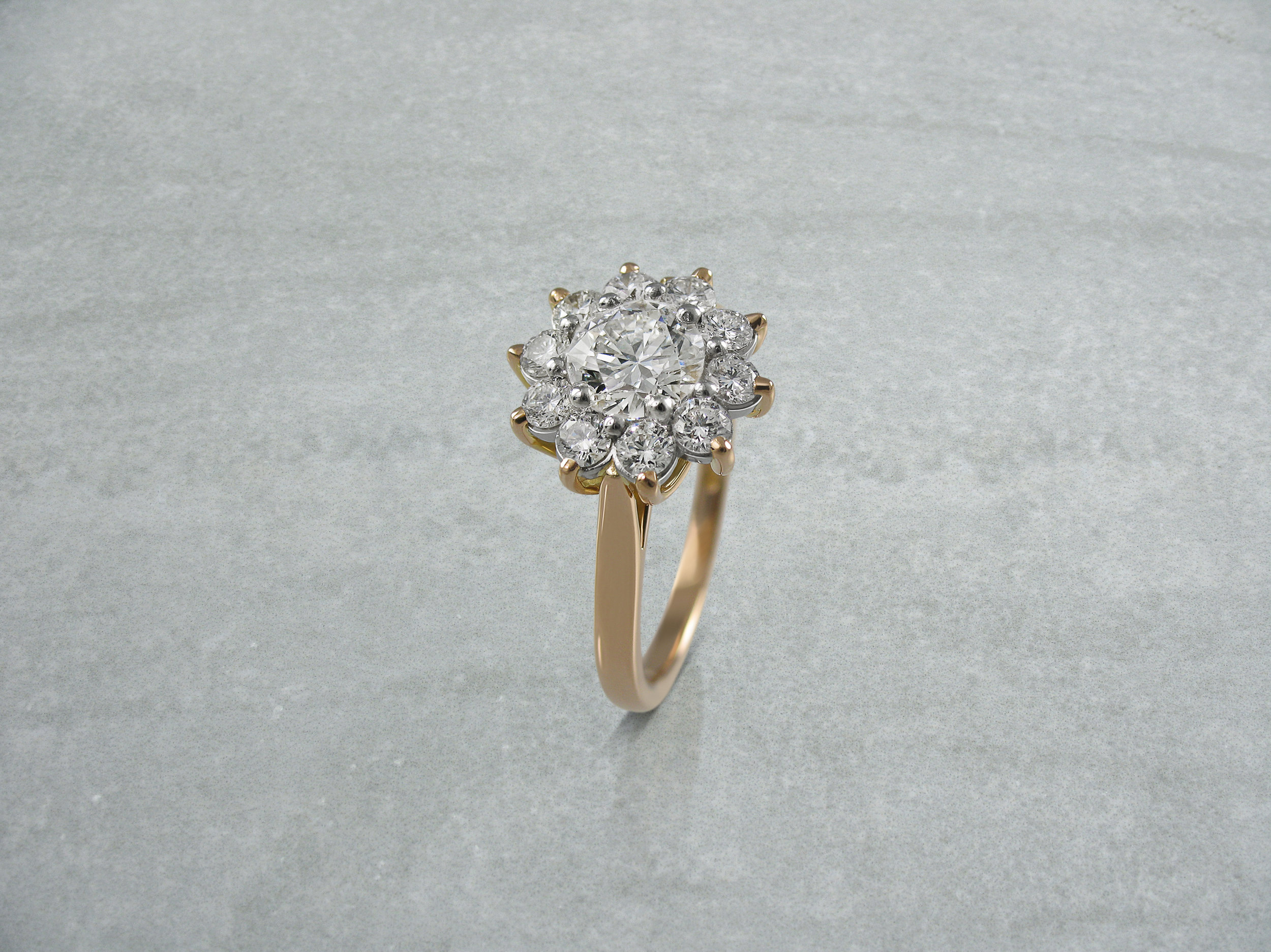 Round brilliant cut diamond rose gold cluster engagement ring