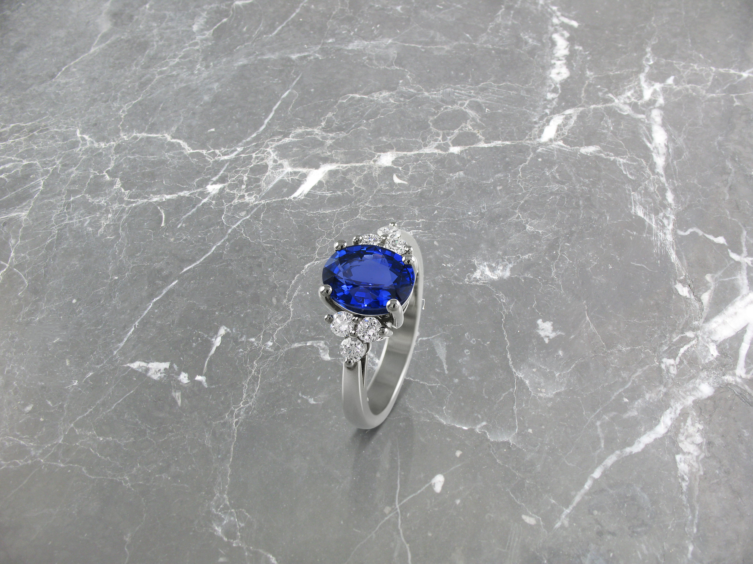 Oval sapphire and diamond trefoil engagement ring