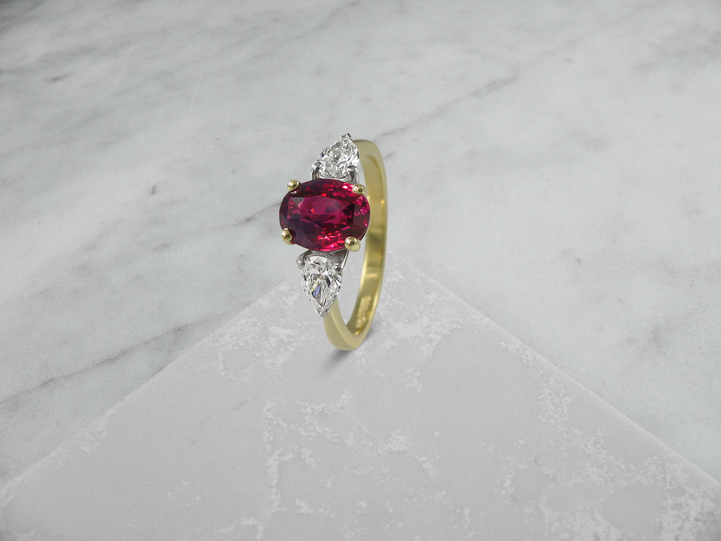 Oval ruby and pear shaped diamond engagement ring