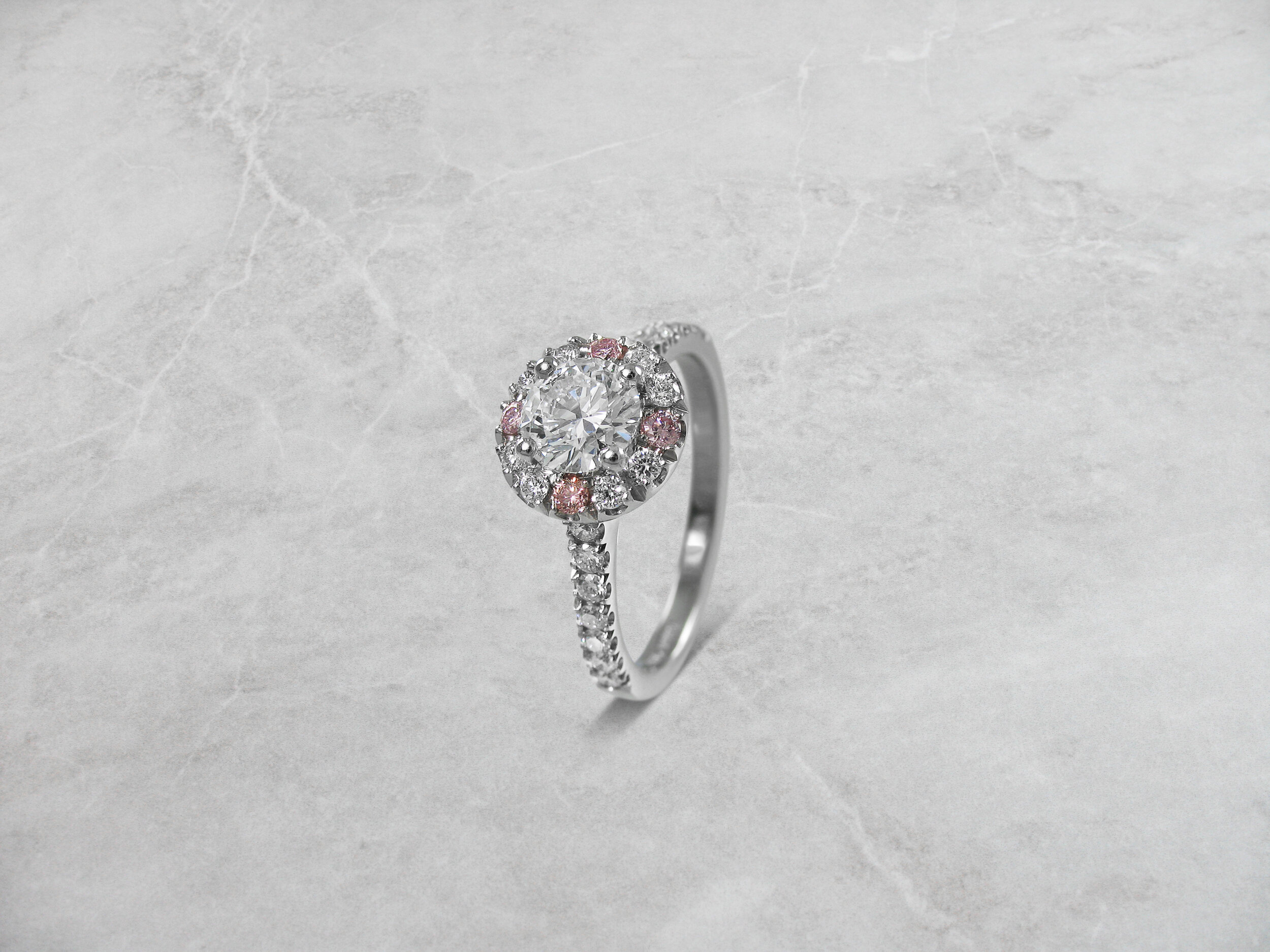 Pink diamond halo engagement ring